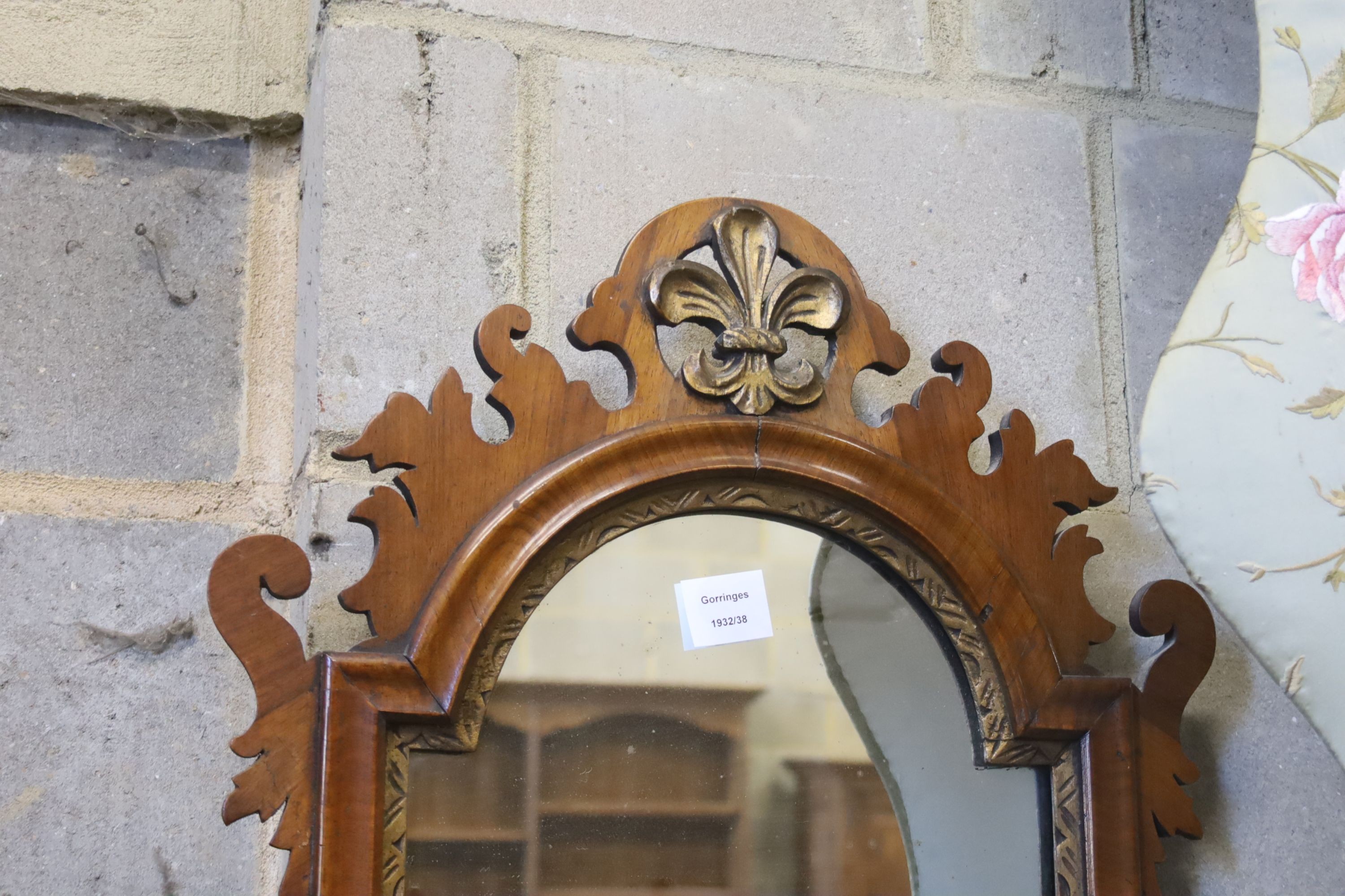 A George III style walnut fret cut and carved giltwood wall mirror, width 49cm, height 86cm